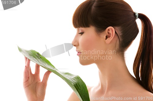 Image of woman with green leaf