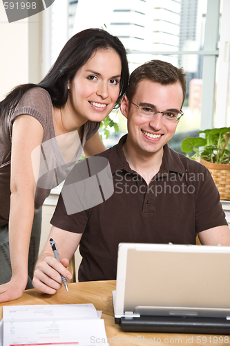 Image of Couple paying bills by online banking