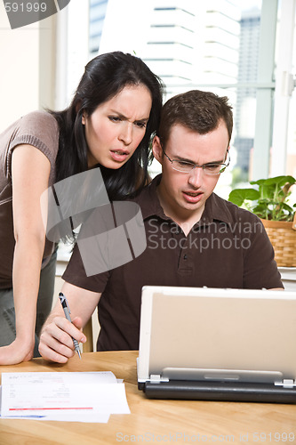 Image of Couple paying bills by online banking