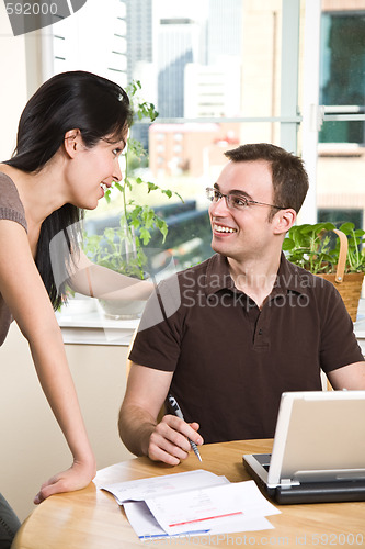 Image of Couple paying bills by online banking
