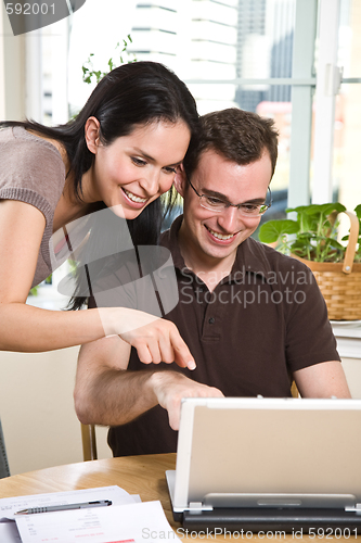 Image of Couple paying bills by online banking