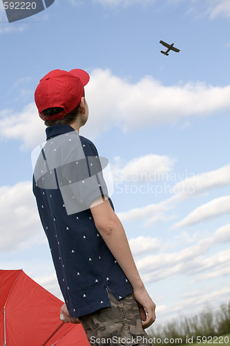 Image of boy looking at plane
