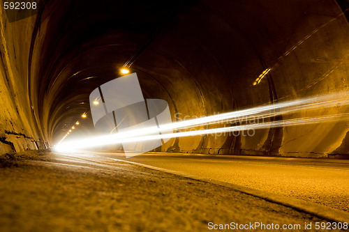 Image of lone car moving fast in tunnel