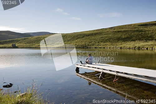 Image of relaxing man on pier