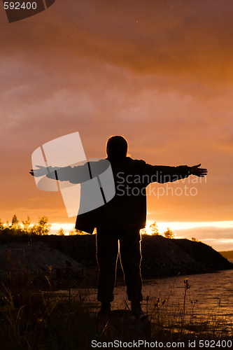 Image of man looks at sunset