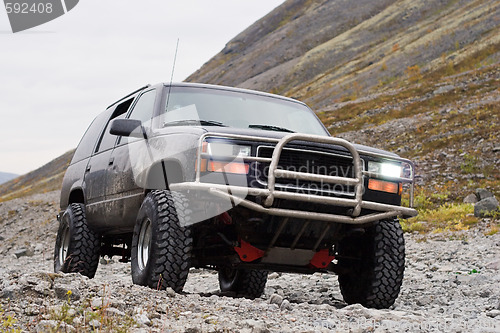 Image of car off-road on mountain background