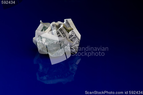 Image of Crumpled dollar isolated on blue