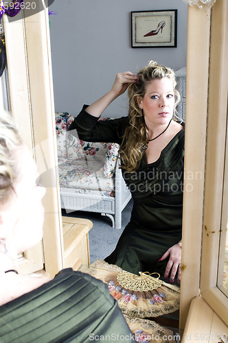 Image of pretty woman applying makeup