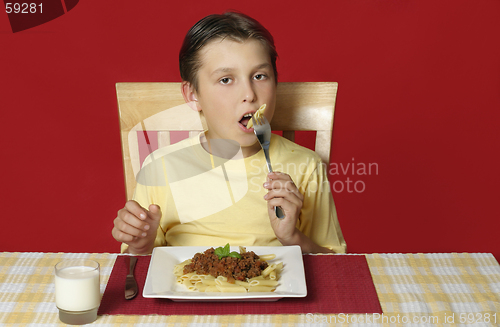 Image of Child eating pasta