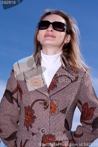 Image of Pretty woman on background blue sky