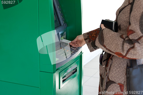 Image of Girl uses bank terminal