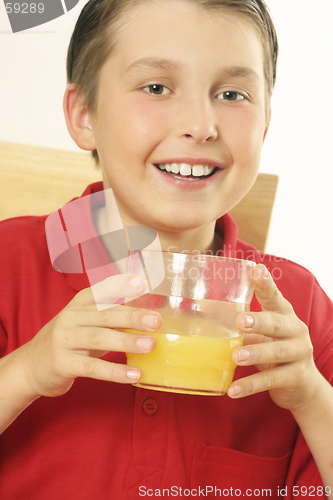 Image of A child drinking orange juice