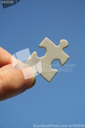 Image of Jigsaw Puzzle in Human Fingers