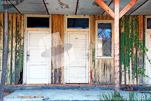 Image of old wooden doors abandoned house