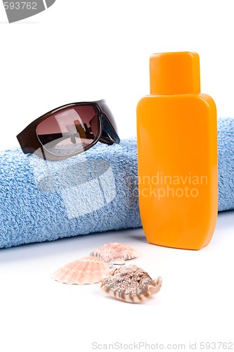 Image of towel, sunglasses and lotion 