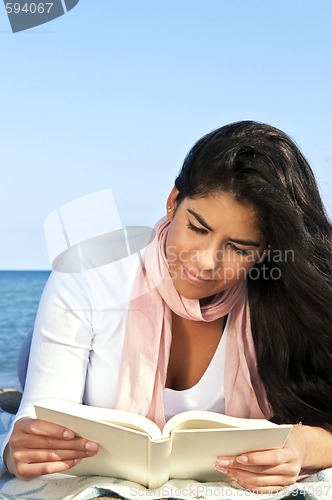 Image of Young native american woman reading