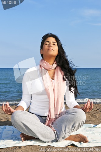 Image of Young native american woman meditating