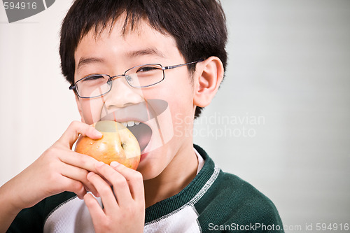 Image of A boy eating an apple