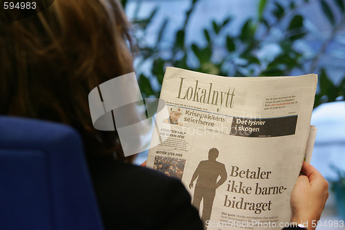 Image of Reading newspaper