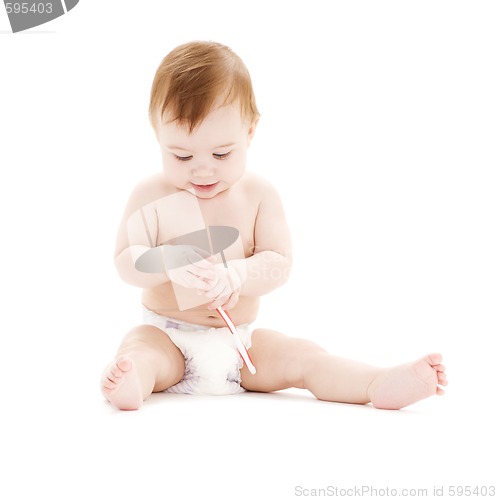 Image of baby boy in diaper with toothbrush