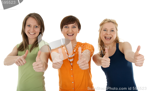 Image of Three happy young women giving thumbs up