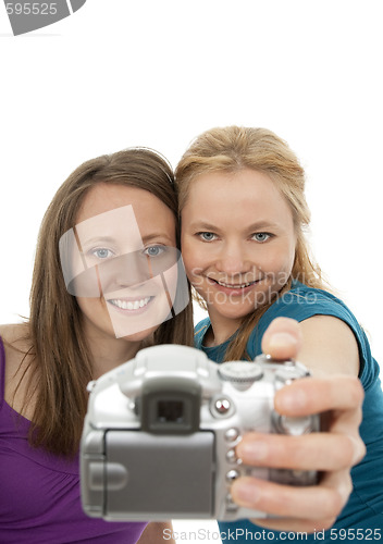 Image of Two pretty girls posing for a camera