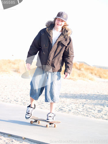 Image of Cool modern skateboarder at the beach