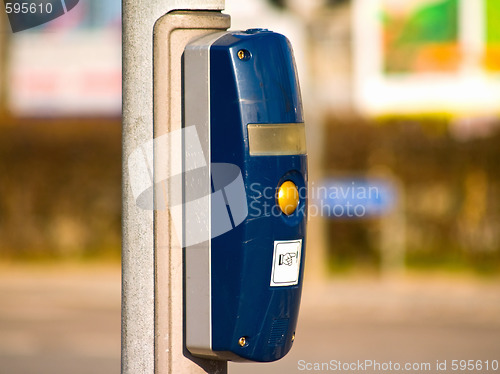 Image of Traffic light button at an intersection in city
