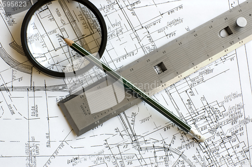 Image of blueprint with pencil, loupe and steel scale ruler