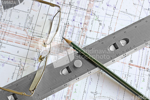 Image of blueprint with pencil, glasses and steel scale ruler