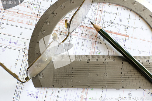 Image of blueprint with pencil, glasses and steel protractor