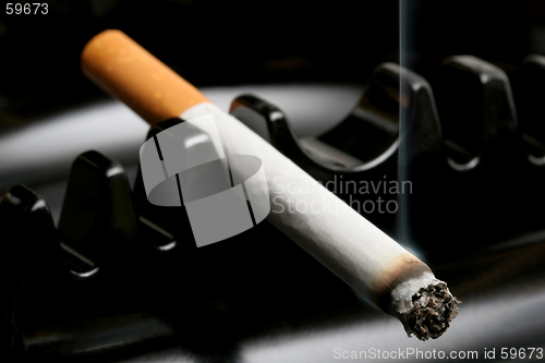 Image of cigarette smoking in ashtray