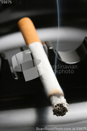 Image of smoking cigarette in ashtray