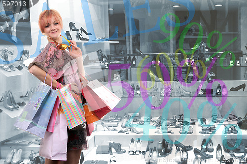 Image of happy young girl with colored bags