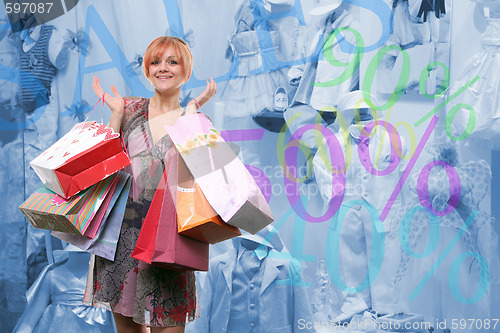 Image of happy young girl with colored bags