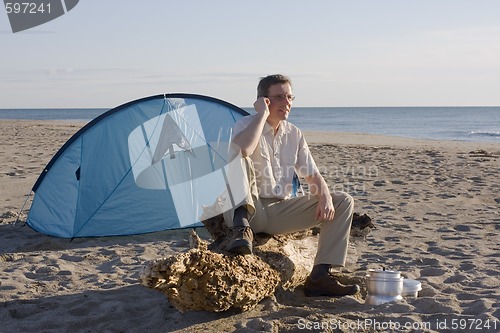 Image of Man with tent on beach