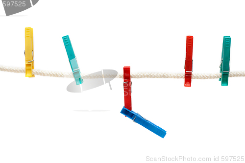 Image of Colour clothes-pegs hung on linen rope