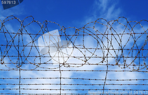 Image of restrictions barbed wire blue sky