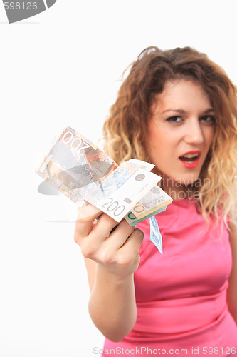 Image of Cheerful young lady holding cash
