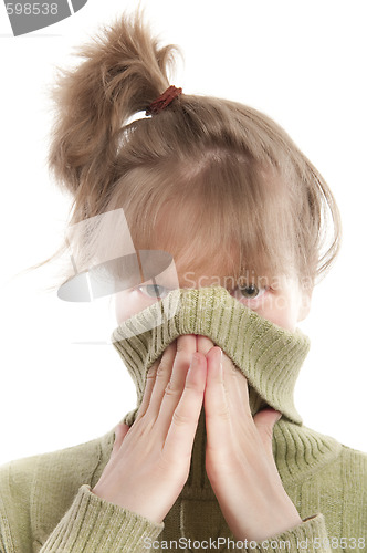 Image of Girl hiding face with hands and sweater collar