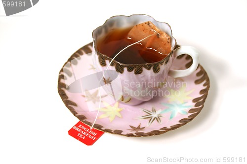 Image of Antique cup with tea bag.