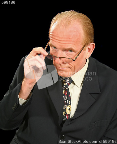 Image of Businessman Looking Over Glasses