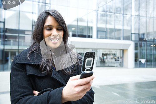 Image of Indian businesswoman texting on the phone