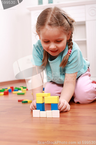 Image of Adorable girl playing with blocks