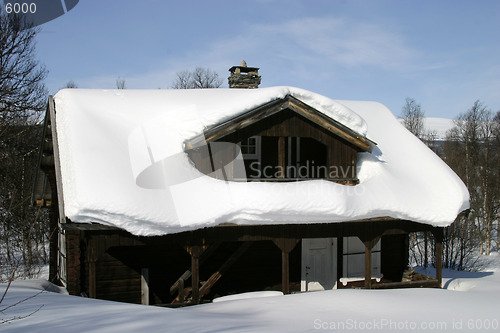 Image of Wooden cabin, covered in a LOT of snow, Norway.