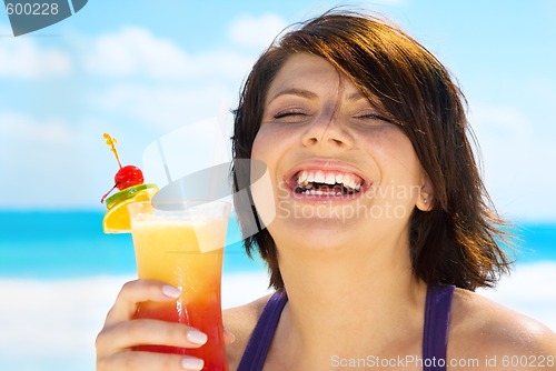 Image of happy woman with colorful cocktail