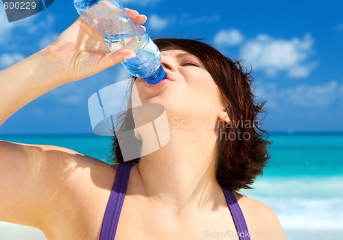 Image of happy woman with bottle of water