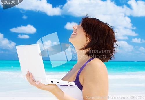 Image of woman with laptop computer on the beach