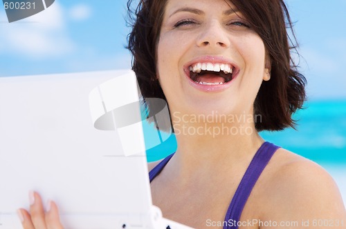 Image of woman with laptop computer on the beach