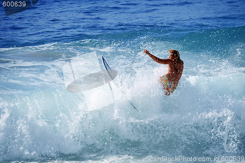 Image of Hawaii, Kauai - Oct 21, 2008: Surfer girl Malia Rimavicus crashes into a wave at training